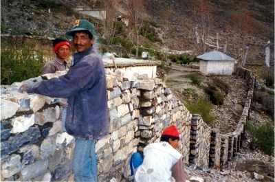 Workers at Muktinath building the new wall.